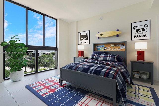 bedroom with multiple windows, a wall of windows, and tile patterned flooring