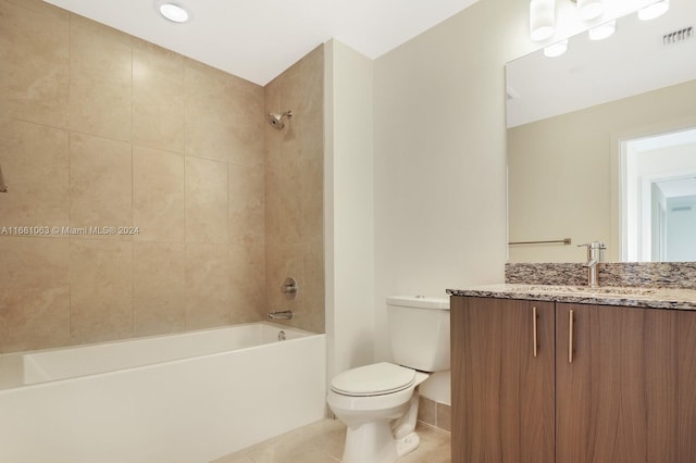 full bathroom featuring tiled shower / bath, vanity, toilet, and tile patterned floors