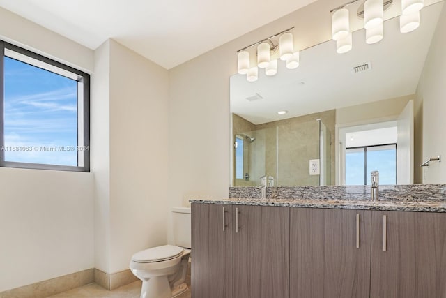 bathroom with toilet, walk in shower, vanity, and tile patterned flooring