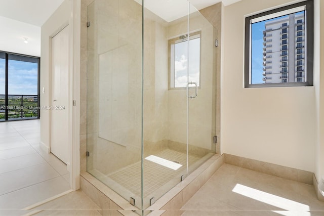 bathroom with tile patterned floors and a shower with shower door