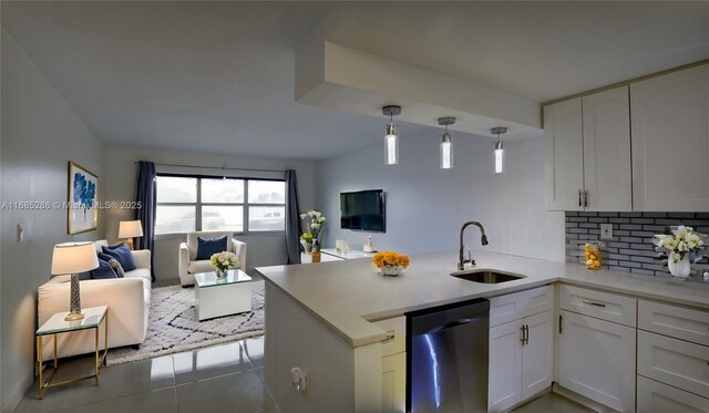 kitchen featuring sink, kitchen peninsula, decorative light fixtures, white cabinets, and appliances with stainless steel finishes