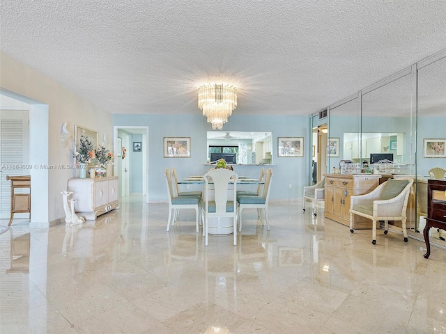 dining area with a notable chandelier and a textured ceiling