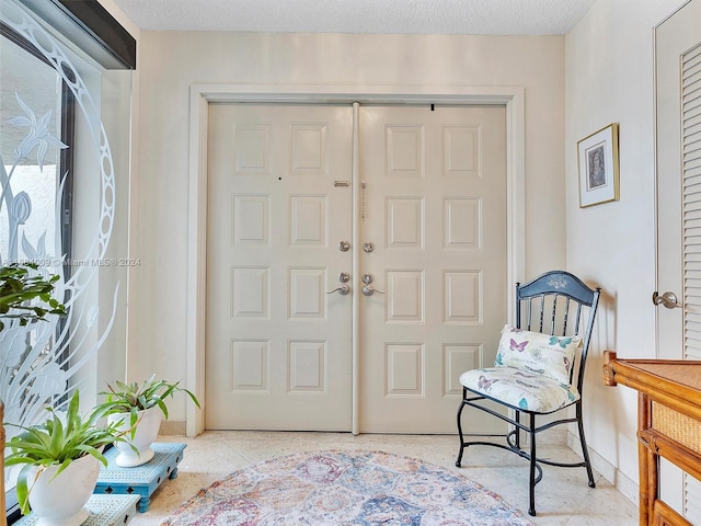 entryway with a textured ceiling