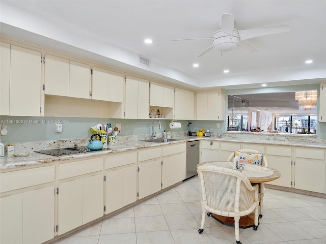 kitchen with cream cabinets, black electric cooktop, sink, light tile patterned floors, and stainless steel dishwasher