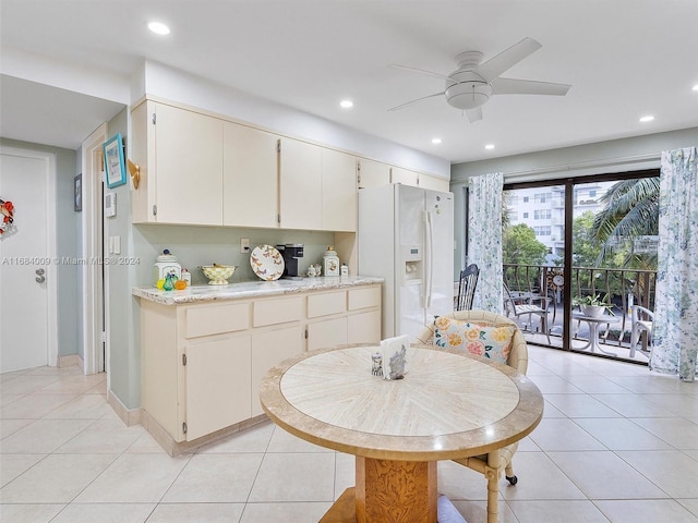 kitchen featuring white fridge with ice dispenser, light tile patterned floors, and ceiling fan