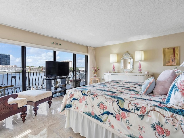 tiled bedroom featuring access to exterior and a textured ceiling