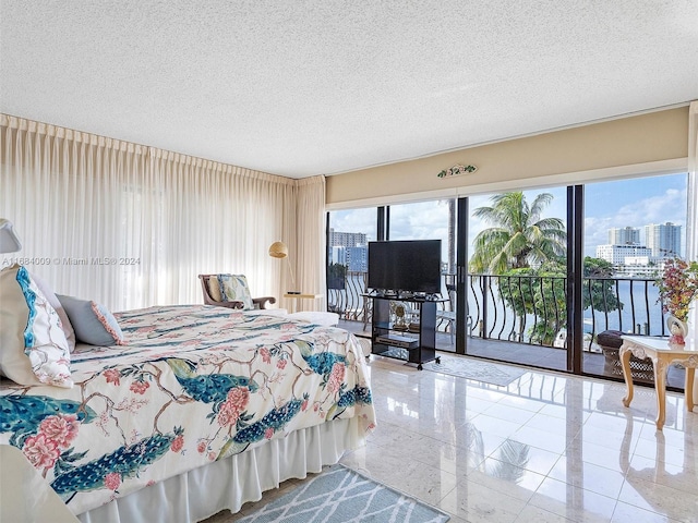 bedroom with access to exterior and a textured ceiling