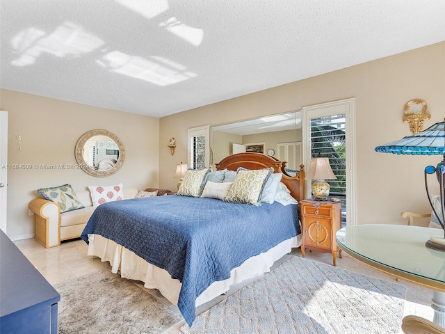 bedroom with a textured ceiling and light tile patterned floors