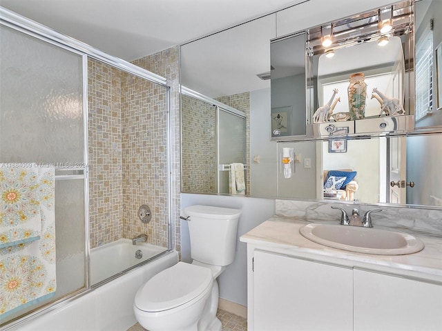 full bathroom with toilet, combined bath / shower with glass door, vanity, and tile patterned floors