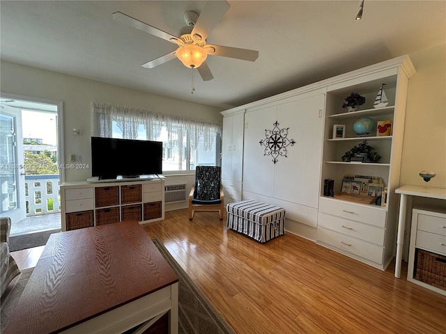 living room with light hardwood / wood-style flooring, ceiling fan, and plenty of natural light