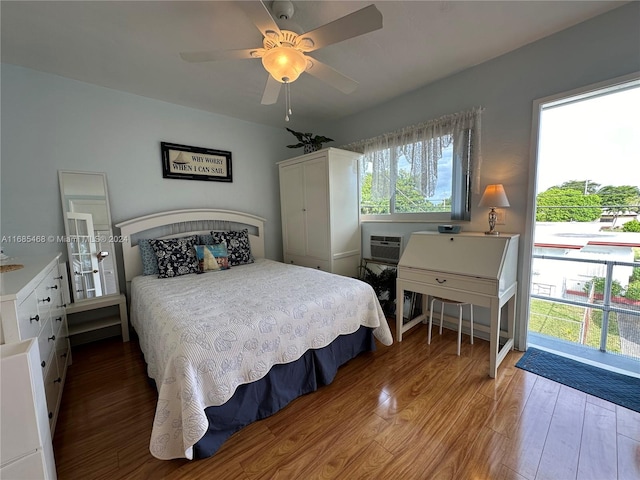 bedroom featuring ceiling fan, a wall mounted AC, and hardwood / wood-style floors