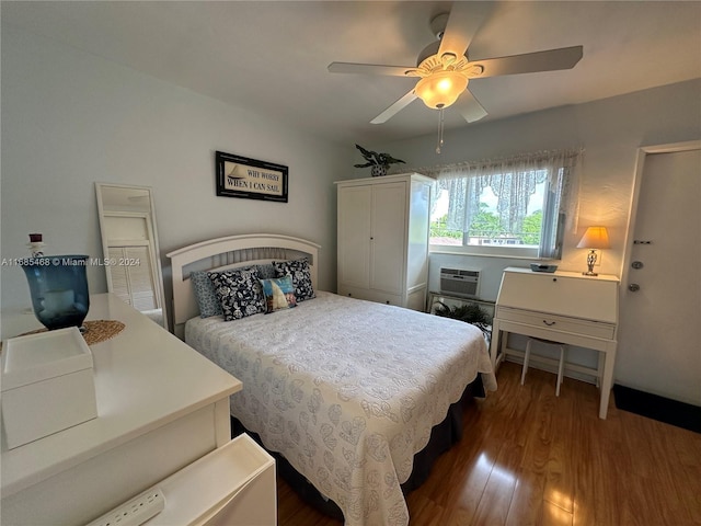 bedroom with ceiling fan, a wall mounted AC, and dark hardwood / wood-style floors