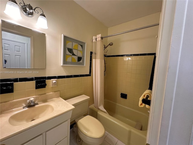 full bathroom with tile walls, toilet, shower / bath combo, vanity, and tile patterned floors