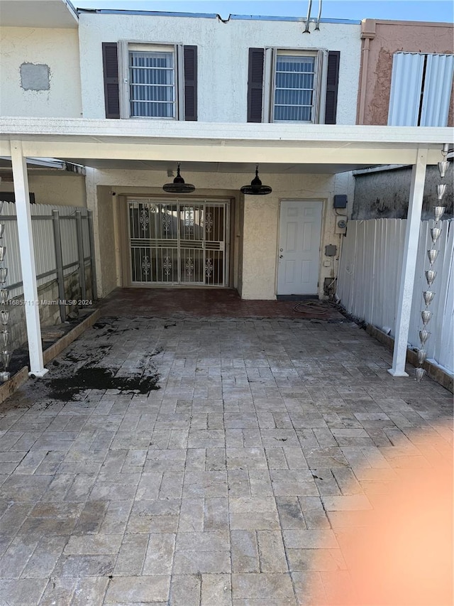 entrance to property with a patio and ceiling fan