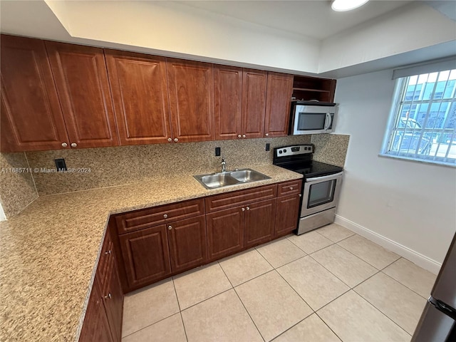 kitchen featuring backsplash, stainless steel appliances, sink, and light tile patterned floors