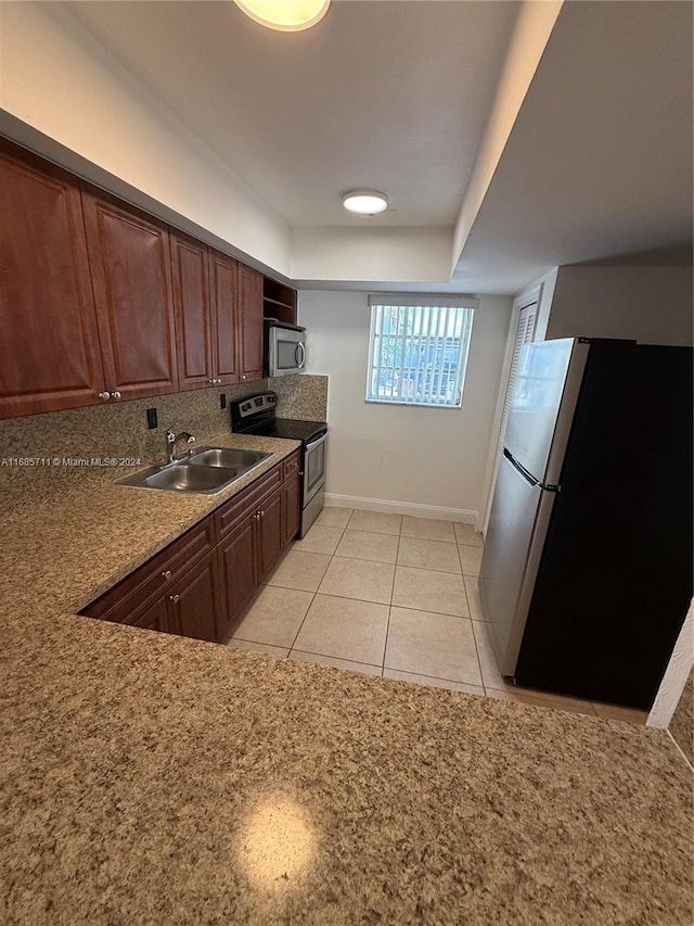 kitchen featuring light tile patterned flooring, stainless steel appliances, and sink