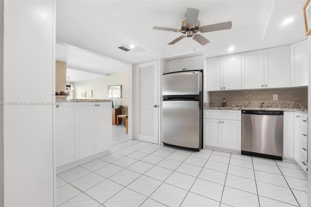 kitchen featuring white cabinets, ceiling fan, tasteful backsplash, kitchen peninsula, and stainless steel appliances