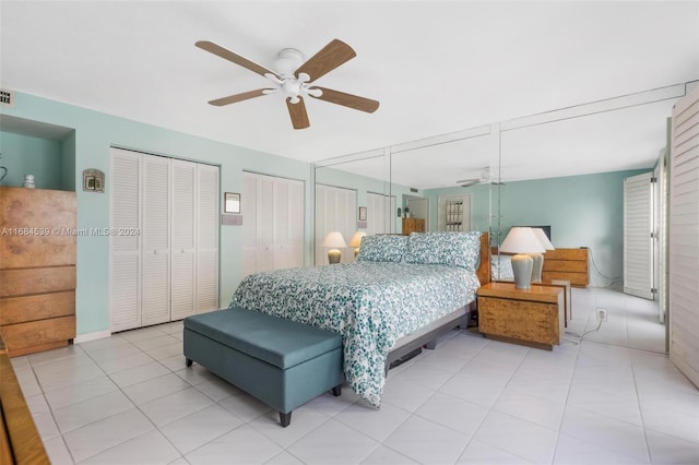 3100 NE 48th St Unit 210, Fort Lauderdale, FL 33308 - bedroom featuring two closets, light tile patterned flooring, and a ceiling fan