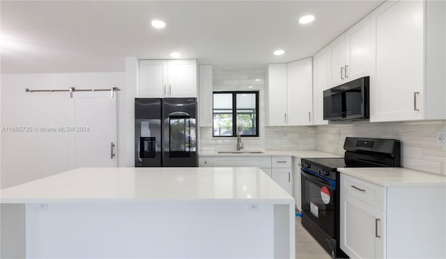 kitchen featuring white cabinetry, black appliances, and sink