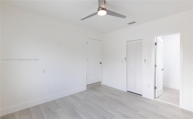 unfurnished bedroom with a closet, ceiling fan, and light hardwood / wood-style flooring