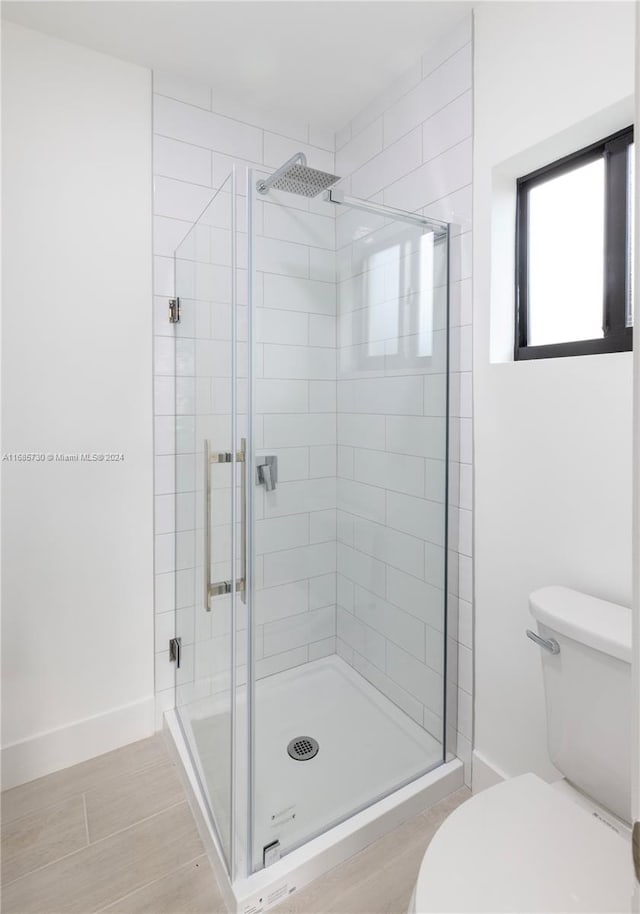 bathroom with toilet and walk in shower