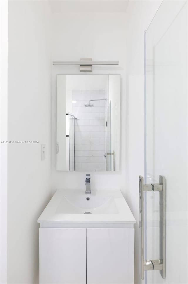 bathroom with vanity and an enclosed shower