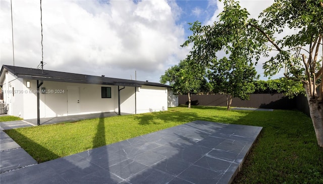 rear view of house featuring a patio area and a lawn