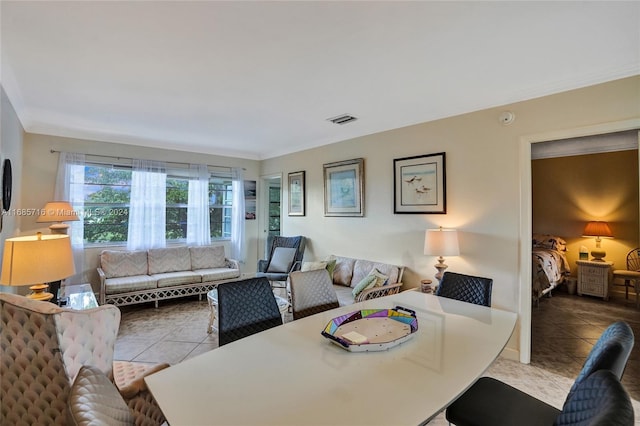 living room with ornamental molding and light tile patterned floors