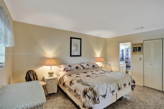 tiled bedroom with a closet, connected bathroom, and ornamental molding