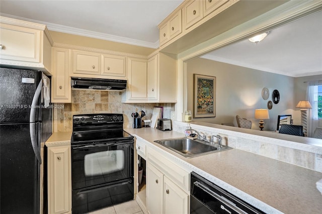 kitchen with sink, black appliances, ornamental molding, and cream cabinets