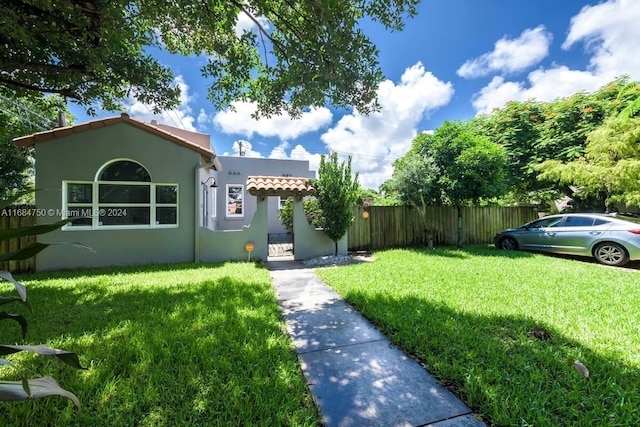 mediterranean / spanish home with a front yard