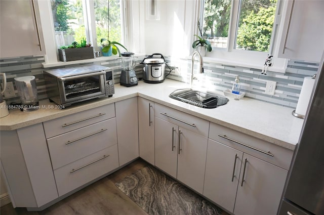 kitchen featuring sink, white cabinetry, and a wealth of natural light