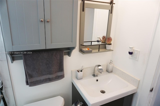 bathroom featuring toilet and vanity