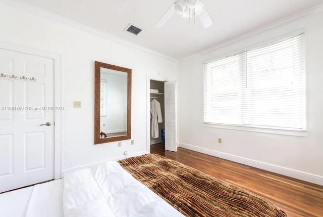 unfurnished bedroom with crown molding, hardwood / wood-style flooring, and ceiling fan