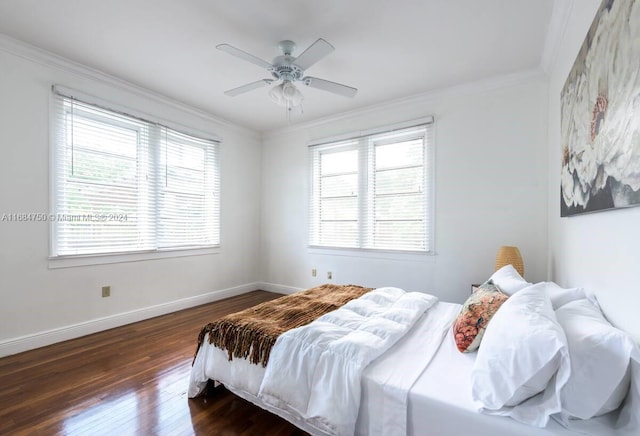 bedroom featuring ceiling fan, ornamental molding, multiple windows, and dark hardwood / wood-style flooring