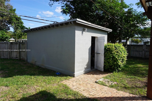 view of outbuilding with a lawn