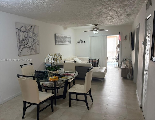 dining room featuring a textured ceiling and ceiling fan