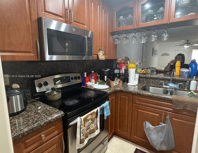 kitchen featuring appliances with stainless steel finishes, tasteful backsplash, ceiling fan, and sink