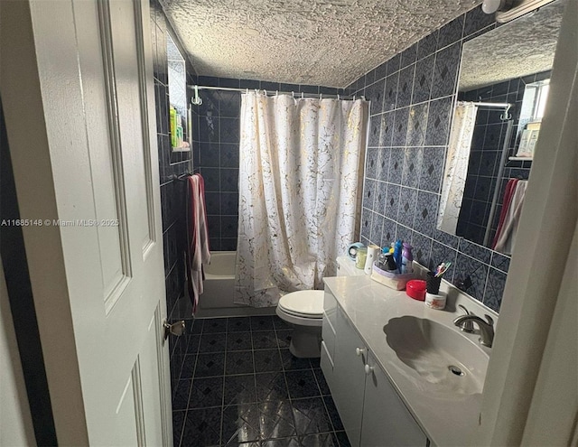 full bathroom featuring vanity, toilet, shower / bathtub combination with curtain, and tile walls