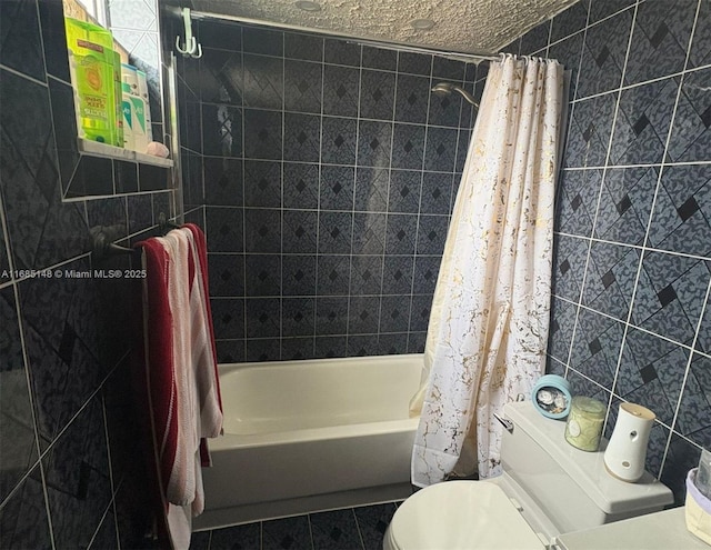 bathroom with tile patterned floors, a textured ceiling, shower / tub combo with curtain, tile walls, and toilet