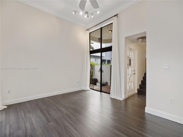 empty room featuring stairway, ceiling fan, crown molding, dark wood-style flooring, and baseboards