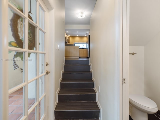 stairway featuring baseboards