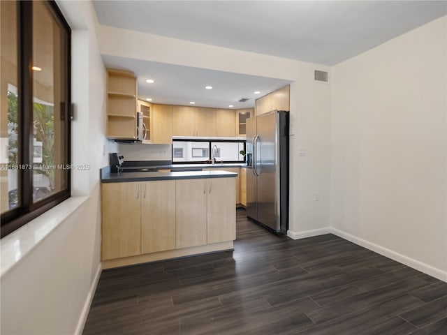 kitchen featuring dark hardwood / wood-style floors, sink, kitchen peninsula, stainless steel appliances, and light brown cabinets