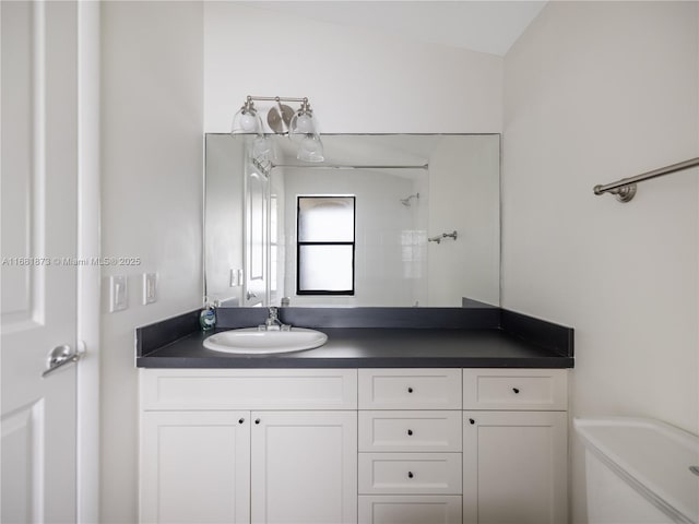 bathroom featuring walk in shower and vanity