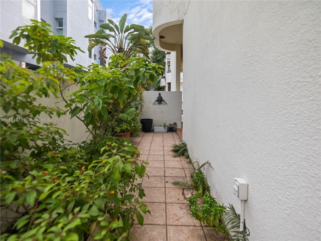 view of property exterior with a patio area