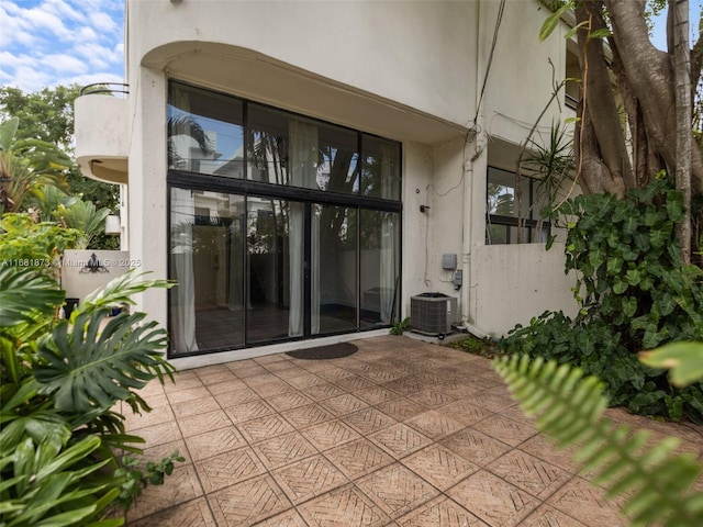 property entrance featuring central AC unit and a patio area