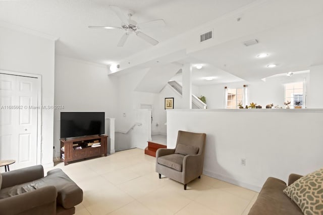 living room with ornamental molding, light tile patterned floors, and ceiling fan