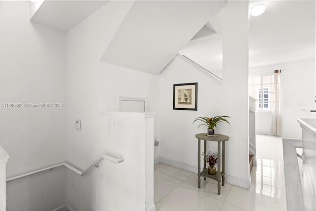 staircase featuring tile patterned flooring