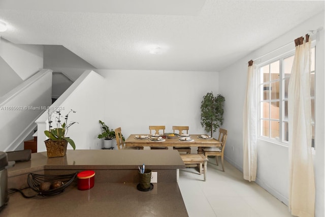 dining area featuring a textured ceiling