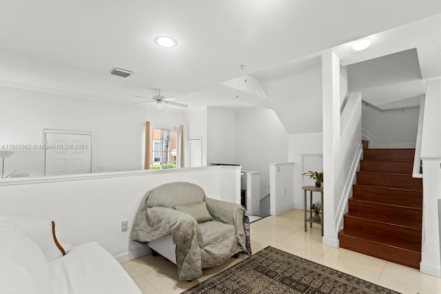 sitting room featuring vaulted ceiling, ceiling fan, and light tile patterned floors